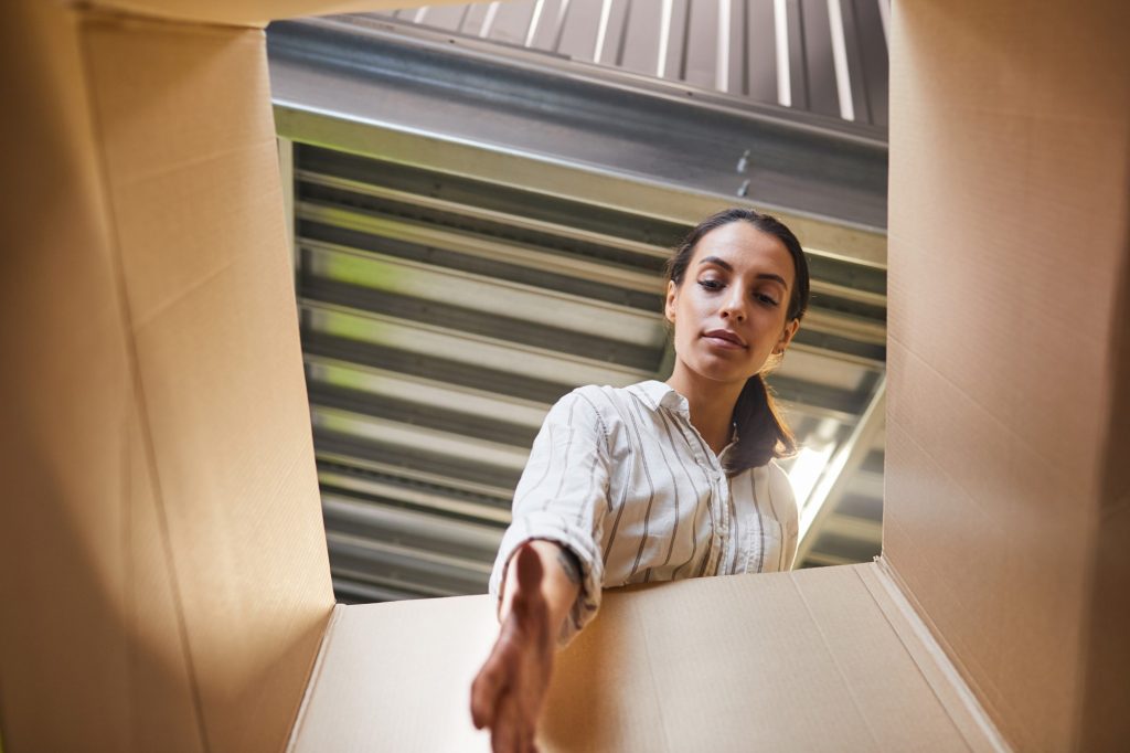 Woman Reaching into Box