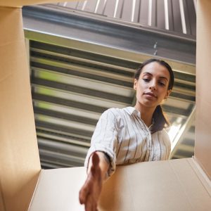 Woman Reaching into Box